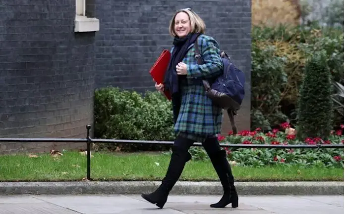 British Secretary of State for International Trade Trevelyan walks outside Downing Street in London